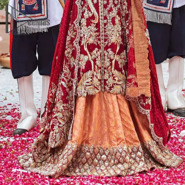 The majestic red signs a melody just for you. The handsome scalloped frock is made in the richest shade of red and specially adorned with dabka, gotta, tilla and the real magic of sequins.  It is prominent with full sleeves and the V shape neckline to introduce the bride as the shining star of the show. It is paired up with a rust lehenga to balance the article. Complete this red article with a dupatta in the same colour which is embellished with four-sided scalloped borders and floral motifs is spread all around to give you the sign of melody on your Big Day.