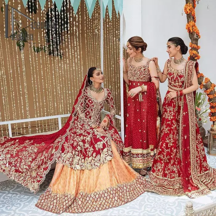 The majestic red signs a melody just for you. The handsome scalloped frock is made in the richest shade of red and specially adorned with dabka, gotta, tilla and the real magic of sequins.  It is prominent with full sleeves and the V shape neckline to introduce the bride as the shining star of the show. It is paired up with a rust lehenga to balance the article. Complete this red article with a dupatta in the same colour which is embellished with four-sided scalloped borders and floral motifs is spread all around to give you the sign of melody on your Big Day.