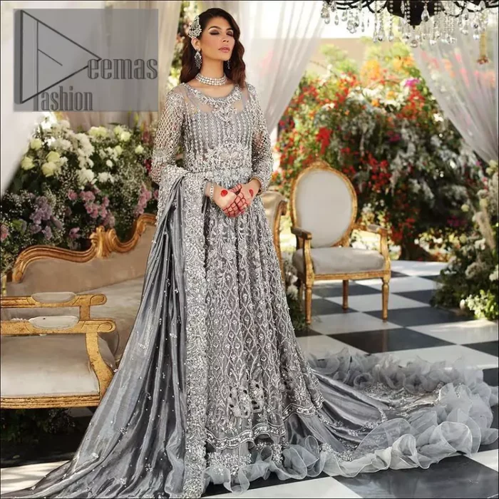 Walking into a new chapter of your life with the joy of togetherness and the magic of love. DeemasFashion presents a silver-grey maxi for your walima day that is handsomely adorned with a silver embroidery that comprises tilla, kora, dabka and crystal work. It is featured with a round neckline and full sleeves that grant you the feeling of joy. Parten this with back train shimmery lehenga which is beautifully organised with the same colour frill that enhances the overall charms of the unique article. Carry this article on your walima day and surprise your loved ones with this fairy look. 