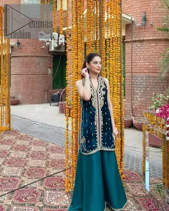 No matter the time and occasion, a pop of blue will always bring you in the bright light. This teal blue short shirt is an exquisite amalgamation of classical golden embroidery and modern cuts. It is prominent with tilla, dabka and kora so everyone looking at you in any event. The V shape neckline increases the beauty of the outfit when combined with the sleeveless style of DeemasFashion. Further, it is coordinated with the same colour palazzo pants that are the bottom line is embellished with golden tiny embroidery to enhance the brightness of your dress.