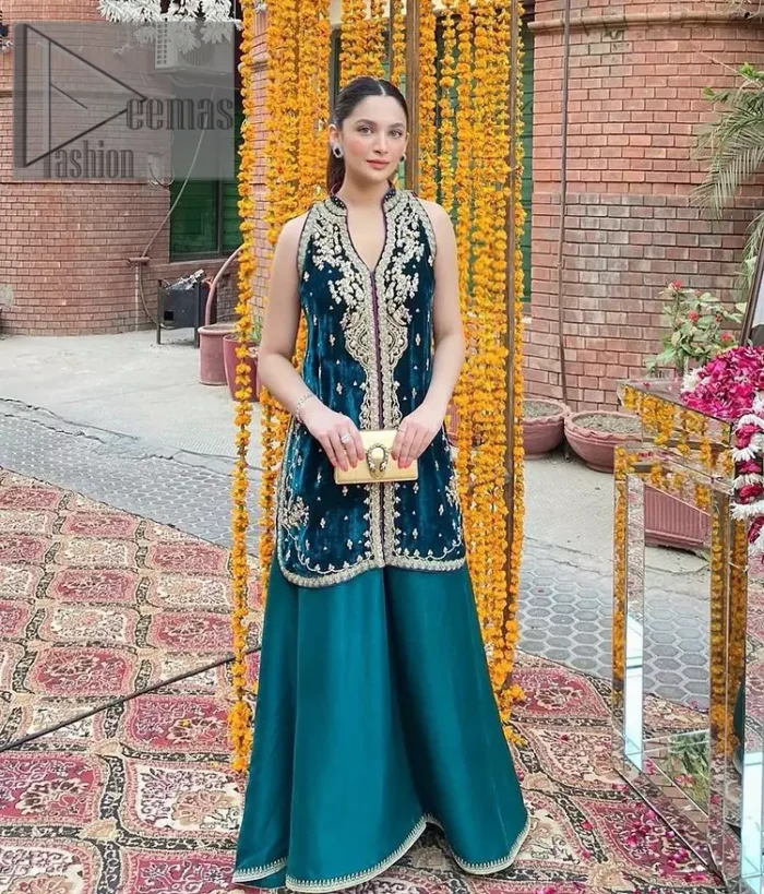 No matter the time and occasion, a pop of blue will always bring you in the bright light. This teal blue short shirt is an exquisite amalgamation of classical golden embroidery and modern cuts. It is prominent with tilla, dabka and kora so everyone looking at you in any event. The V shape neckline increases the beauty of the outfit when combined with the sleeveless style of DeemasFashion. Further, it is coordinated with the same colour palazzo pants that are the bottom line is embellished with golden tiny embroidery to enhance the brightness of your dress.