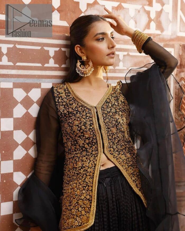 With the timeless charm of black so back on traditional flavour to steal everyone's heart. Introducing the black jacket that is the epitome of splendour with delicate details beautifully decorated with golden colour. The bodice of the jacket is enhanced with stunning embroidery with worked finishing of tilla, kora, dabka and zardozi. The addition of simple sleeves with V shape neckline can be done to make this super traditional. To complete this traditional jacket, a crushed sharara is added to give you an amazing look at any formal event. Complete this black outfit with a black dupatta in a plain style that is perfect for any intimate evening 