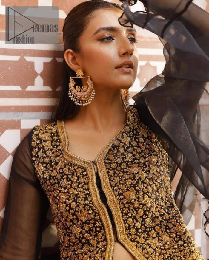 With the timeless charm of black so back on traditional flavour to steal everyone's heart. Introducing the black jacket that is the epitome of splendour with delicate details beautifully decorated with golden colour. The bodice of the jacket is enhanced with stunning embroidery with worked finishing of tilla, kora, dabka and zardozi. The addition of simple sleeves with V shape neckline can be done to make this super traditional. To complete this traditional jacket, a crushed sharara is added to give you an amazing look at any formal event. Complete this black outfit with a black dupatta in a plain style that is perfect for any intimate evening 