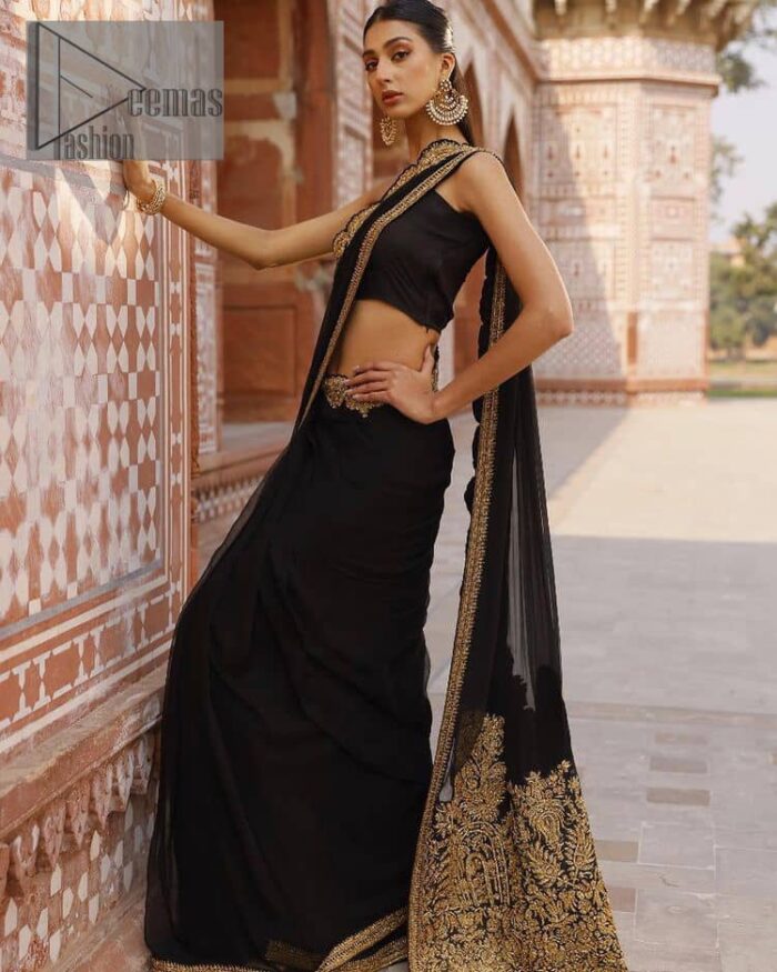 Every saree tells a story! Black is always the reason behind any smile at parties. DeemasFashion also presents a formal saree in black that you can wear at any function or party. The black blouse having sleeveless and strap neckline gives you so soothing and romantic look. Further, the simplicity of the blouse enhances the beauty of the outfit. It comes with a pure black saree which is ornamented with golden embroidery. It is highlighted with tilla, kora, and dabka work on borders. The pallu of the saree is also prominent with golden embridery. 