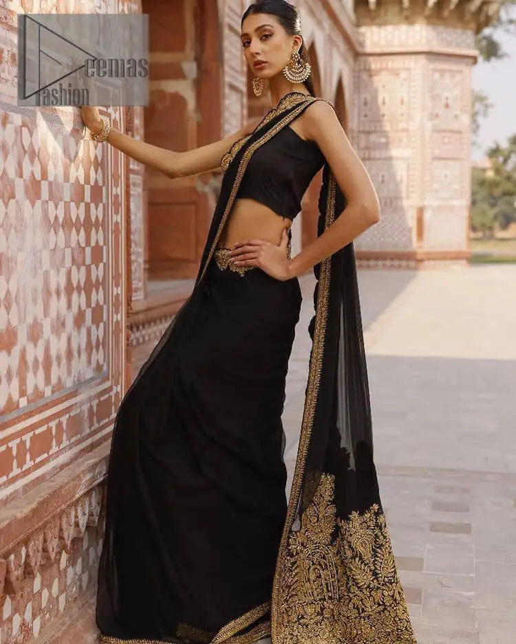 Every saree tells a story! Black is always the reason behind any smile at parties. DeemasFashion also presents a formal saree in black that you can wear at any function or party. The black blouse having sleeveless and strap neckline gives you so soothing and romantic look. Further, the simplicity of the blouse enhances the beauty of the outfit. It comes with a pure black saree which is ornamented with golden embroidery. It is highlighted with tilla, kora, and dabka work on borders. The pallu of the saree is also prominent with golden embridery.