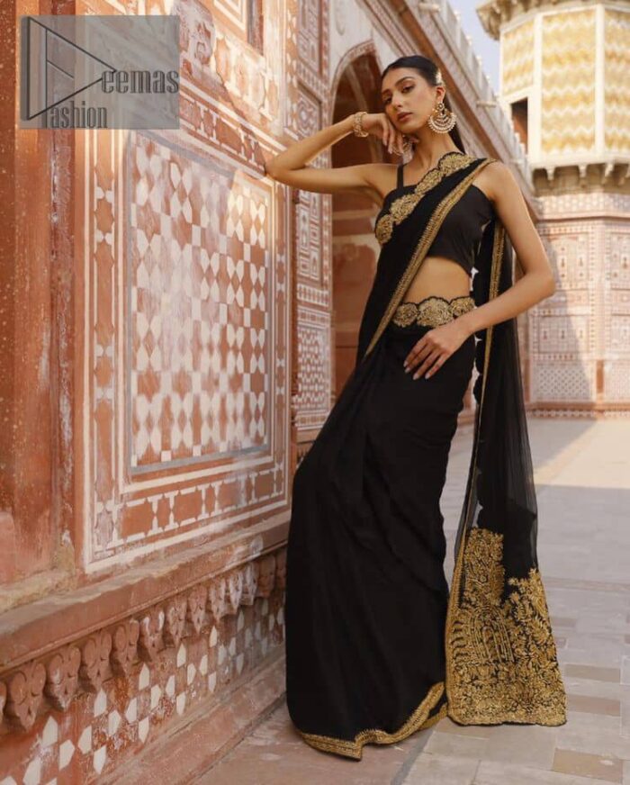 Every saree tells a story! Black is always the reason behind any smile at parties. DeemasFashion also presents a formal saree in black that you can wear at any function or party. The black blouse having sleeveless and strap neckline gives you so soothing and romantic look. Further, the simplicity of the blouse enhances the beauty of the outfit. It comes with a pure black saree which is ornamented with golden embroidery. It is highlighted with tilla, kora, and dabka work on borders. The pallu of the saree is also prominent with golden embridery. 