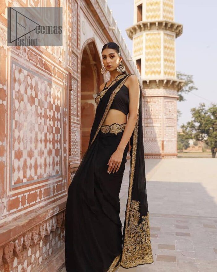Every saree tells a story! Black is always the reason behind any smile at parties. DeemasFashion also presents a formal saree in black that you can wear at any function or party. The black blouse having sleeveless and strap neckline gives you so soothing and romantic look. Further, the simplicity of the blouse enhances the beauty of the outfit. It comes with a pure black saree which is ornamented with golden embroidery. It is highlighted with tilla, kora, and dabka work on borders. The pallu of the saree is also prominent with golden embridery. 