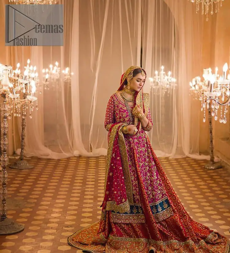 Do you also want to give you a look of the traditional brides on your Mehandi? Make your moment memorable being a queen in our magenta front open shirt with intricately embroidered neckline and embellished with delicate kora, dabka, tilla work all over. A green border of the shirt gives the perfect look to the outfit. It is organized with a red back train jamawar lehenga to give you the look of such a traditional bride. Complete this outfit with a red dupatta which is laboriously adorned with a four-sided border and ting floral motifs all over to give you such a super traditional Mehandi bride vibe.