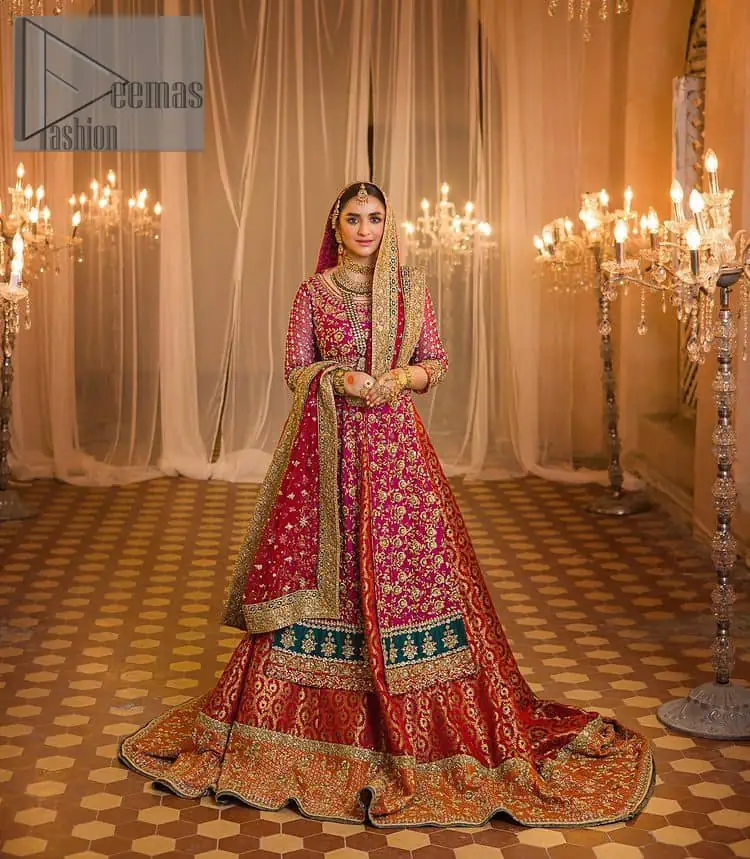 Do you also want to give you a look of the traditional brides on your Mehandi? Make your moment memorable being a queen in our magenta front open shirt with intricately embroidered neckline and embellished with delicate kora, dabka, tilla work all over. A green border of the shirt gives the perfect look to the outfit. It is organized with a red back train jamawar lehenga to give you the look of such a traditional bride. Complete this outfit with a red dupatta which is laboriously adorned with a four-sided border and ting floral motifs all over to give you such a super traditional Mehandi bride vibe.