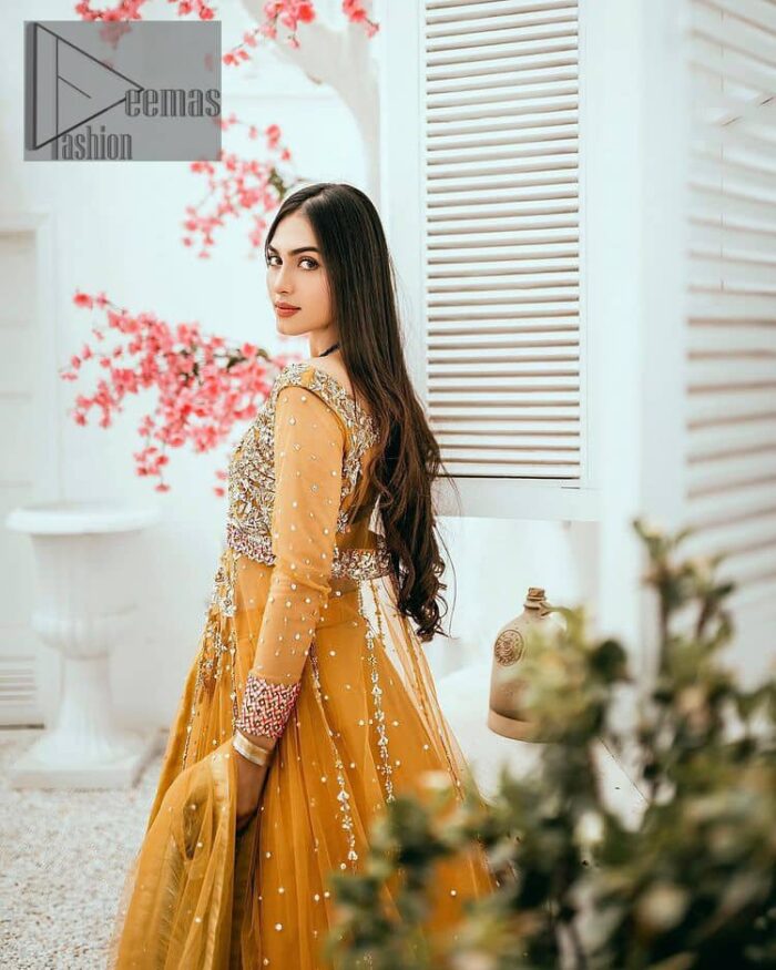Mustard is just associated and boosts your Mehandi.  Presenting a dreamy mustard frock with a heavily embroidered bodice on a silver base. The bodice is further enhanced with handwork that includes crystal, tilla, kora and dabka work. Furthermore, the boat shape neckline and tiny work on full sleeves have the super style just to boost your day. The bottom is decorated with artistic embroidery that is adding glam to it. The Mehandi look is completed with an artistically crafted frilled lehenga which frill borders displaying the traditional hint of charm. It is coordinated with a dupatta in the same colour that is embellished with four-sided borders as well. 