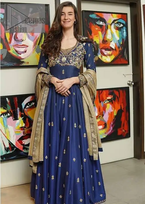 Hues of blues make a funky yet amazing pattern on amazing events. DeemasFashion introduces a navy blue outfit. Starting this article with a navy blue multiple panel frock which is ornamented with golden embroidery. The pattern of embroidery begins with the round neckline which is handsomely embellished with tilla, dabka, kora and Kundan. It is further prominent with full sleeves. The rest of the frock is decorated with floral motifs in a golden hue. The following frock comes with a golden dupatta to complete the admiring look on any day or night event. 