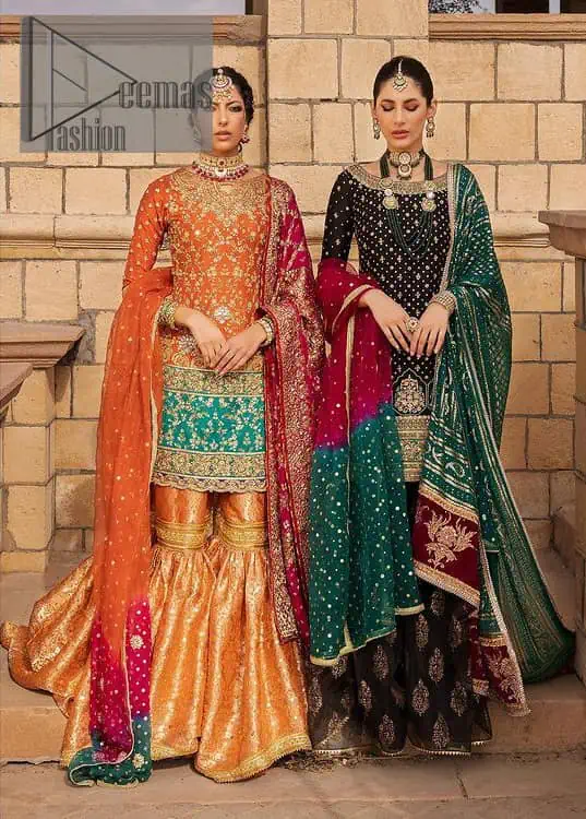 Be a happy and charming bride just like orange is a happy colour. DeemasFashion presents you with an orange short shit that is laboriously embellished with golden embroidery. The base of embroidery starts from the boat shape neckline of the shirt that giving a fully artistic look. In addition to this, it is enhanced with tilla, dabka, kora and Kundan work. The half sleeves of the dhirt also enhance the beauty of the handwork. It is coordinated with orange gharara that is perfect for entimate evening of your Mehandi. Finish this outfit with Pink dupatta that is adorned with ravishing details, the embellished borders represent the craftsmanship of DeemasFashion.