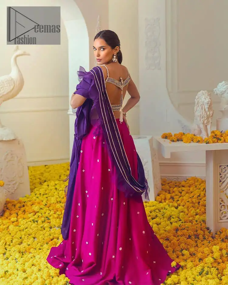 The magenta and purple imitation of traditional crafted patterns on the luxury outfits. The beautiful purple blouse is rendered with handsome silver embellishment. It is highlighted with kora, dabka, crystal and zardozi embroidery. The sleeveless style gives an attractive layer when comes with a strap neckline. The following shirt comes with an intricately embellished magenta can can lehenga to embrace the superstar look. Complete this article with an exquisite purple dupatta adorned with a lushly encrusted border. The beautiful frill in the same hue is also attached.