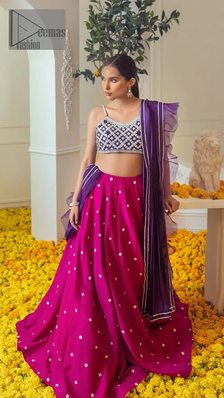 The magenta and purple imitation of traditional crafted patterns on the luxury outfits. The beautiful purple blouse is rendered with handsome silver embellishment. It is highlighted with kora, dabka, crystal and zardozi embroidery. The sleeveless style gives an attractive layer when comes with a strap neckline. The following shirt comes with an intricately embellished magenta can can lehenga to embrace the superstar look. Complete this article with an exquisite purple dupatta adorned with a lushly encrusted border. The beautiful frill in the same hue is also attached.