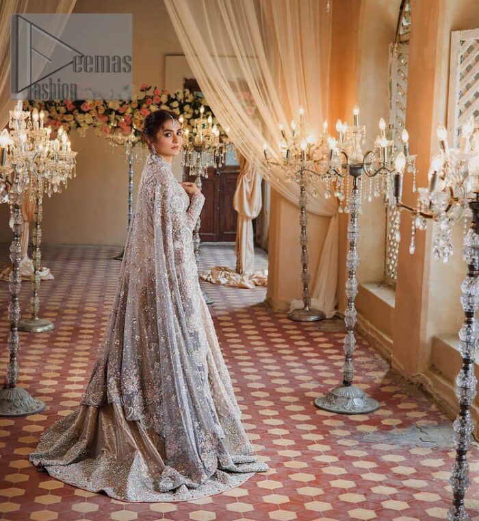 Amplify your style on your Walima day in this stunning light color. DeemasFashion presents the super handsome rose gold outfit for you. First of all, which includes back train maxi in the rose gold colour. It is prominent with the silver embroidery that is encrusted with pearls, silver crystals, kora, dabka and sequins all over highlighting floral patterns. Further, it is emphasized with boat shape neckline and full sleeves that increase the opulent statement of the outfit. It is organized with rose gold sharara which is also embellished with heavy silver embroidery to make your day super dazzling. Finish this look with the rose gold dupatta that is accentuated with sequins and booti spray all over and adorned with a four-sided matha Patti border. 