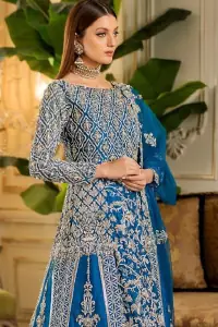 When it comes to the premium worthiness of bridal wear, the Royal Blue Blouse Lehenga takes the lead. A distinctive full-sleeved bridal wear featuring a boat-shaped neckline ensures all the eminence one would possibly desire on her big day. Its can-can style, ravishing traditional geometric patterns, and mesmerizing floral motifs speak for the attire's dexterous craftsmanship. To intensify its supremacy, an elegant work of silver embroidery is styled with scrupulous attention to the minutest details. The choice of fabric is always made by paying special attention to the attire's gracefulness, gorgeousness, comfort, and attraction. Henceforth, this marvellous attire with a heavy centre panel uses pure organza as its highly ravishing fabric, making the dress stunning for your Walima or Reception day.