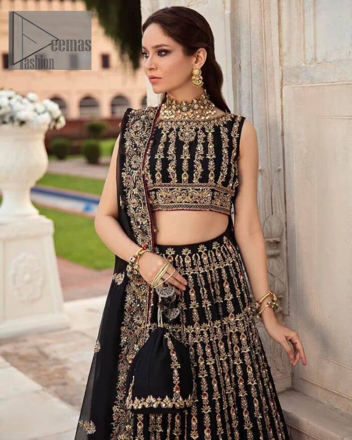 Black is the second way to show romanticness. This black article is attractively rendered with golden embroidery in which details speak for themselves. First of all the blouse in the article is as amazing as in the picture. It is further prominent with tilla, dabka, crystal and kora to enhance the power of black. The boat shape neckline also increases the beauty of the blouse when comes with a sleeveless style. Further, it is paired up with a black can-can lehenga which is heavily embellished with golden embroidery. Complete this look with a black dupatta which is again rendered with four-sided borders and floral motifs all over.