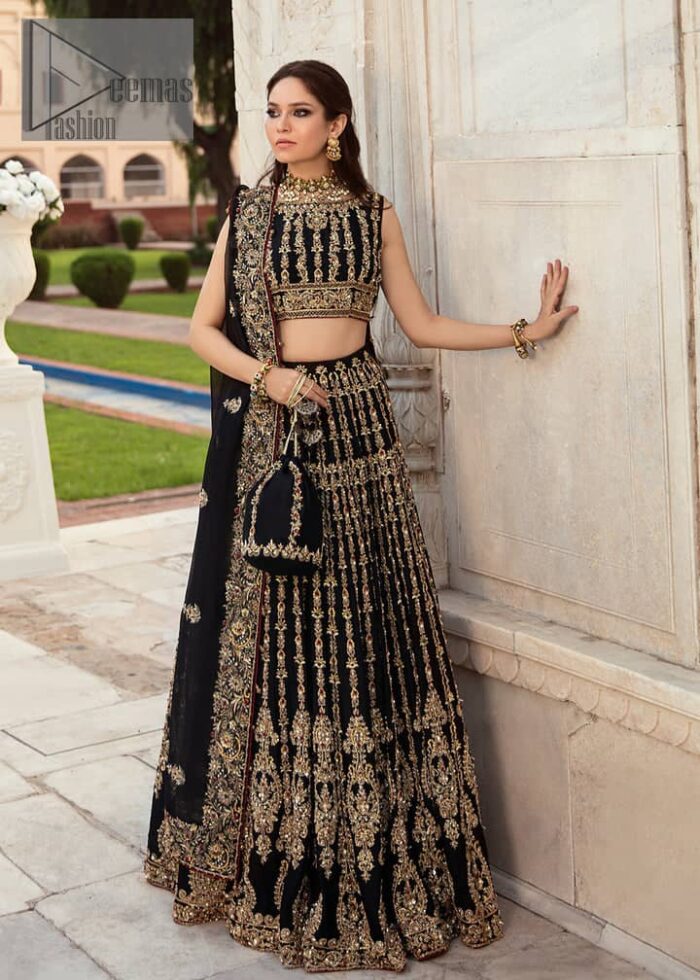Black is the second way to show romanticness. This black article is attractively rendered with golden embroidery in which details speak for themselves. First of all the blouse in the article is as amazing as in the picture. It is further prominent with tilla, dabka, crystal and kora to enhance the power of black. The boat shape neckline also increases the beauty of the blouse when comes with a sleeveless style. Further, it is paired up with a black can-can lehenga which is heavily embellished with golden embroidery. Complete this look with a black dupatta which is again rendered with four-sided borders and floral motifs all over.