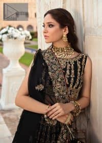 Black is the second way to show romanticness. This black article is attractively rendered with golden embroidery in which details speak for themselves. First of all the blouse in the article is as amazing as in the picture. It is further prominent with tilla, dabka, crystal and kora to enhance the power of black. The boat shape neckline also increases the beauty of the blouse when comes with a sleeveless style. Further, it is paired up with a black can-can lehenga which is heavily embellished with golden embroidery. Complete this look with a black dupatta which is again rendered with four-sided borders and floral motifs all over.