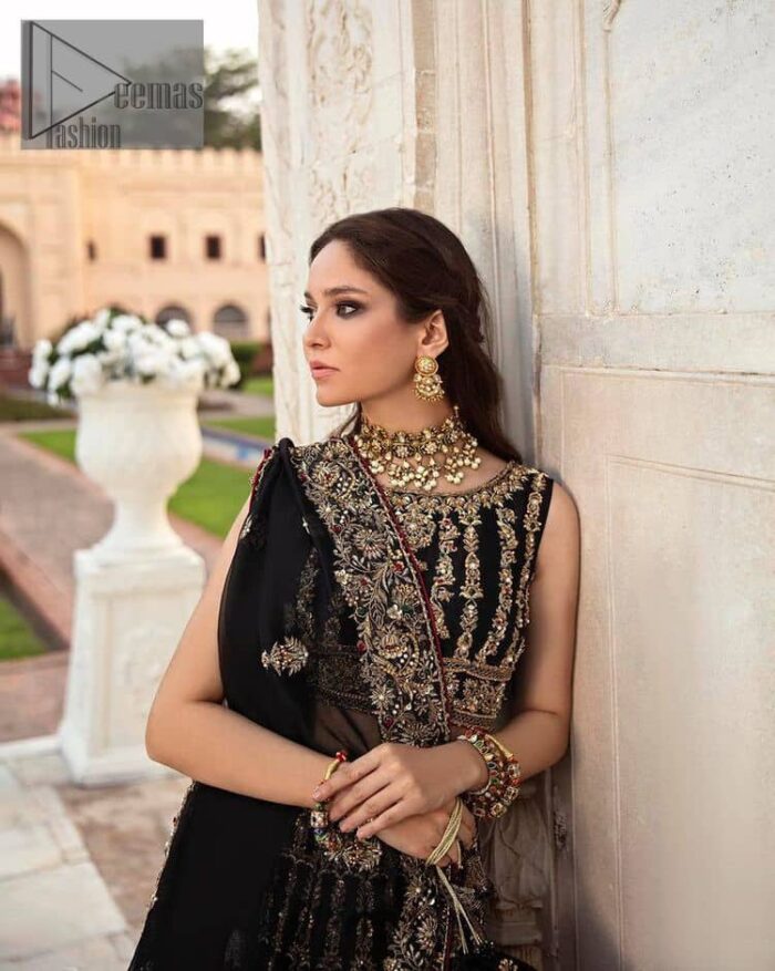 Black is the second way to show romanticness. This black article is attractively rendered with golden embroidery in which details speak for themselves. First of all the blouse in the article is as amazing as in the picture. It is further prominent with tilla, dabka, crystal and kora to enhance the power of black. The boat shape neckline also increases the beauty of the blouse when comes with a sleeveless style. Further, it is paired up with a black can-can lehenga which is heavily embellished with golden embroidery. Complete this look with a black dupatta which is again rendered with four-sided borders and floral motifs all over.