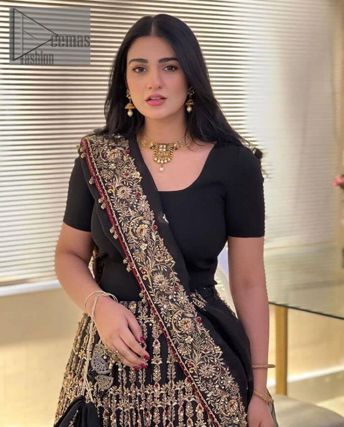 Black is the second way to show romanticness. This black article is attractively rendered with golden embroidery in which details speak for themselves. First of all the blouse in the article is as amazing as in the picture. It is further prominent with tilla, dabka, crystal and kora to enhance the power of black. The boat shape neckline also increases the beauty of the blouse when comes with a sleeveless style. Further, it is paired up with a black can-can lehenga which is heavily embellished with golden embroidery. Complete this look with a black dupatta which is again rendered with four-sided borders and floral motifs all over.