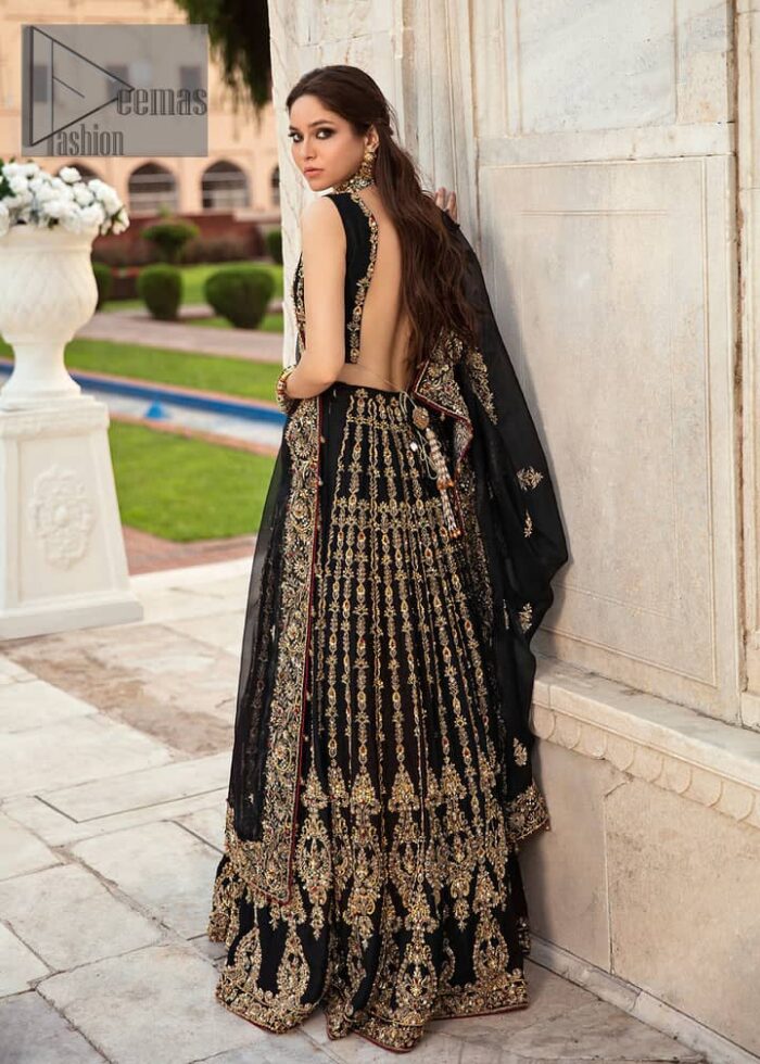 Black is the second way to show romanticness. This black article is attractively rendered with golden embroidery in which details speak for themselves. First of all the blouse in the article is as amazing as in the picture. It is further prominent with tilla, dabka, crystal and kora to enhance the power of black. The boat shape neckline also increases the beauty of the blouse when comes with a sleeveless style. Further, it is paired up with a black can-can lehenga which is heavily embellished with golden embroidery. Complete this look with a black dupatta which is again rendered with four-sided borders and floral motifs all over.