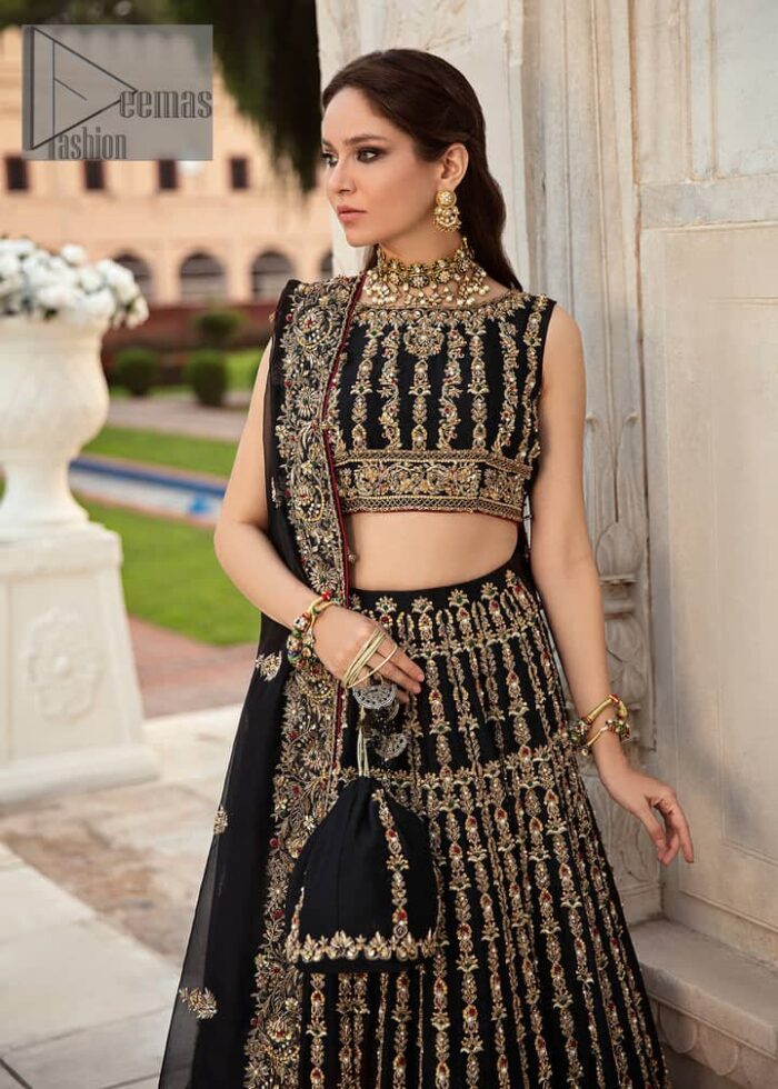 Black is the second way to show romanticness. This black article is attractively rendered with golden embroidery in which details speak for themselves. First of all the blouse in the article is as amazing as in the picture. It is further prominent with tilla, dabka, crystal and kora to enhance the power of black. The boat shape neckline also increases the beauty of the blouse when comes with a sleeveless style. Further, it is paired up with a black can-can lehenga which is heavily embellished with golden embroidery. Complete this look with a black dupatta which is again rendered with four-sided borders and floral motifs all over.