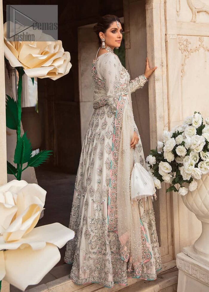 Ivory is effortlessly snappy and fun with the essence of pop. Introducing the Walima outfit for the happiest bride. Starting the outfit with an astonishing blouse having golden embroidery which includes kora, dabka, tilla and Kundan to make this outfit a unique piece of fun. Further, it is enhanced with boat shape neckline with intimate full sleeves. It is beautifully organized with a can-can lehenga in the same colour to embrace the magic of love. The floral embroidery on the lehenga gives a super aesthetic feeling to the outfit. Finish this look with the handsome dupatta in the same hue having a four-sided embellished border and sequins sprayed all over to show the essence of pop.