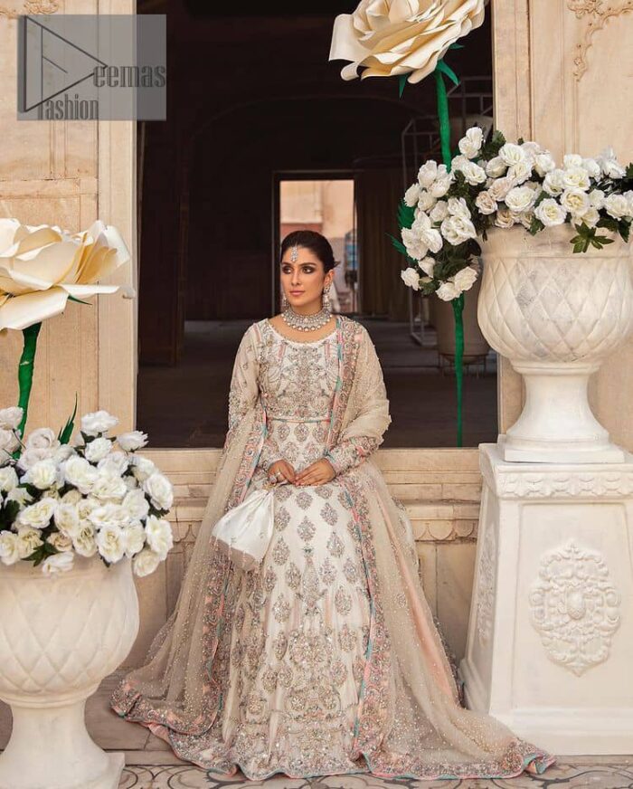 Ivory is effortlessly snappy and fun with the essence of pop. Introducing the Walima outfit for the happiest bride. Starting the outfit with an astonishing blouse having golden embroidery which includes kora, dabka, tilla and Kundan to make this outfit a unique piece of fun. Further, it is enhanced with boat shape neckline with intimate full sleeves. It is beautifully organized with a can-can lehenga in the same colour to embrace the magic of love. The floral embroidery on the lehenga gives a super aesthetic feeling to the outfit. Finish this look with the handsome dupatta in the same hue having a four-sided embellished border and sequins sprayed all over to show the essence of pop.