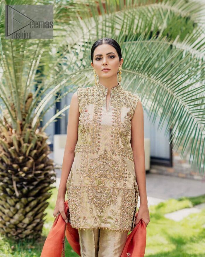 Envelop yourself into a dazzling love affair. The unique article in ivory colour just highlighted you at any event. The short shirt of the article is handsomely decorated with golden embroidery which includes kora, dabka, tilla, Kundan and Sitara work to make your event blazing and dazzling.  It is enhanced with a collared neckline to make this outfit more formal when come with a sleeveless style. Further, it is coordinated with pant which is embellished with golden embroidery. Last but not least piece the dupatta comes in rust colour having four-sided embellished borders to encapsulate you in stars.