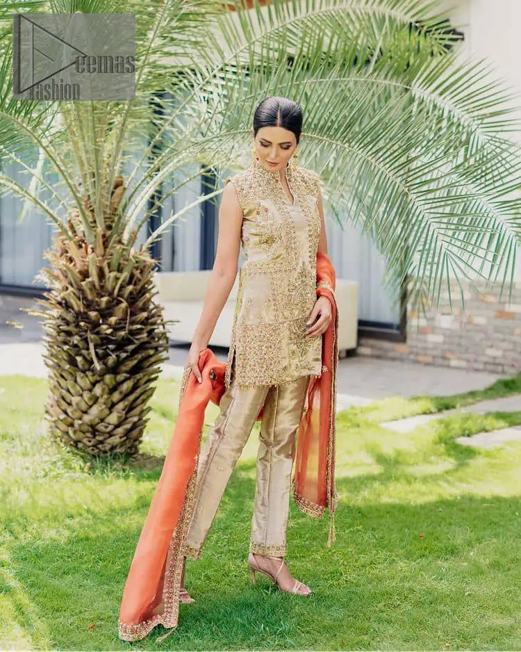 Envelop yourself into a dazzling love affair. The unique article in ivory colour just highlighted you at any event. The short shirt of the article is handsomely decorated with golden embroidery which includes kora, dabka, tilla, Kundan and Sitara work to make your event blazing and dazzling. It is enhanced with a collared neckline to make this outfit more formal when come with a sleeveless style. Further, it is coordinated with pant which is embellished with golden embroidery. Last but not least piece the dupatta comes in rust colour having four-sided embellished borders to encapsulate you in stars.