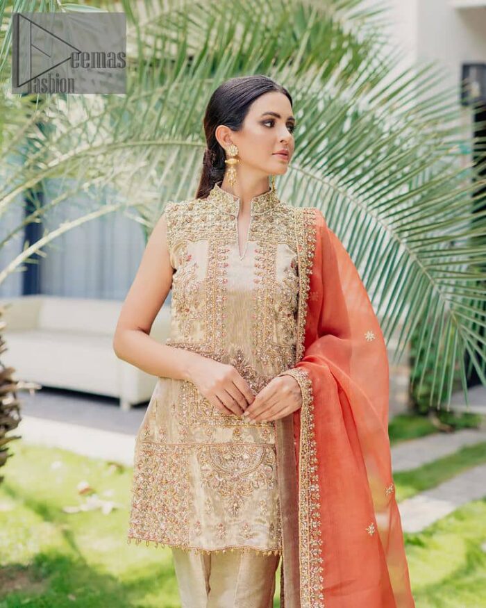 Envelop yourself into a dazzling love affair. The unique article in ivory colour just highlighted you at any event. The short shirt of the article is handsomely decorated with golden embroidery which includes kora, dabka, tilla, Kundan and Sitara work to make your event blazing and dazzling.  It is enhanced with a collared neckline to make this outfit more formal when come with a sleeveless style. Further, it is coordinated with pant which is embellished with golden embroidery. Last but not least piece the dupatta comes in rust colour having four-sided embellished borders to encapsulate you in stars.