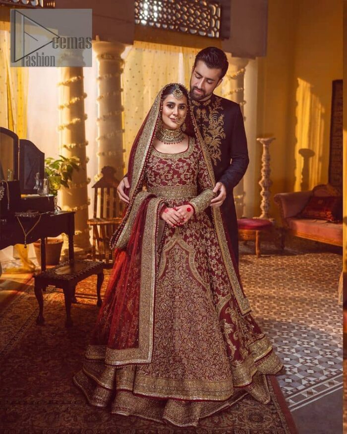 Take me to your heart, for it's there that I belong. A pure outfit base in maroon as a canvas to meticulously designed golden bloomings all over to show the real-time magic of tilla, kora, dabka and zardozi. The round neckline of the traditional pishwas highlighted the incrusted beauty of the outfit. Further, the full sleeve of the following pishwas is wearable art on your big day. It is systemized with a heavy lehenga to give you a more traditional look. Complete this maroon outfit with a dupatta in the same hue having four-sided embellished borders and sequins sprayed all over to show the colour of love.