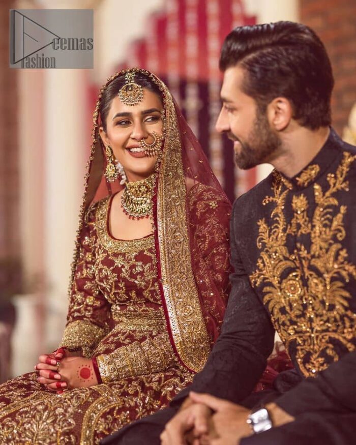 Take me to your heart, for it's there that I belong. A pure outfit base in maroon as a canvas to meticulously designed golden bloomings all over to show the real-time magic of tilla, kora, dabka and zardozi. The round neckline of the traditional pishwas highlighted the incrusted beauty of the outfit. Further, the full sleeve of the following pishwas is wearable art on your big day. It is systemized with a heavy lehenga to give you a more traditional look. Complete this maroon outfit with a dupatta in the same hue having four-sided embellished borders and sequins sprayed all over to show the colour of love.