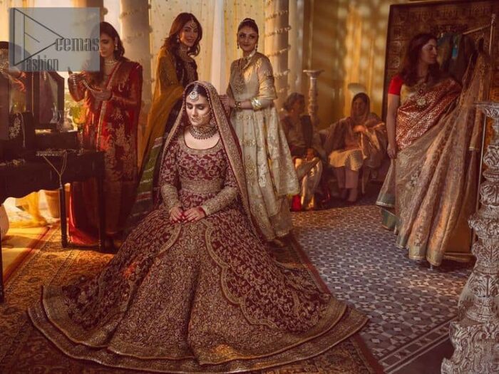 Take me to your heart, for it's there that I belong. A pure outfit base in maroon as a canvas to meticulously designed golden bloomings all over to show the real-time magic of tilla, kora, dabka and zardozi. The round neckline of the traditional pishwas highlighted the incrusted beauty of the outfit. Further, the full sleeve of the following pishwas is wearable art on your big day. It is systemized with a heavy lehenga to give you a more traditional look. Complete this maroon outfit with a dupatta in the same hue having four-sided embellished borders and sequins sprayed all over to show the colour of love.