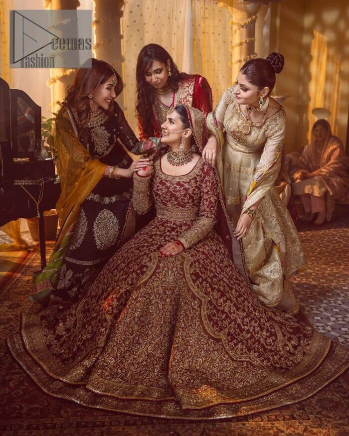 Take me to your heart, for it's there that I belong. A pure outfit base in maroon as a canvas to meticulously designed golden bloomings all over to show the real-time magic of tilla, kora, dabka and zardozi. The round neckline of the traditional pishwas highlighted the incrusted beauty of the outfit. Further, the full sleeve of the following pishwas is wearable art on your big day. It is systemized with a heavy lehenga to give you a more traditional look. Complete this maroon outfit with a dupatta in the same hue having four-sided embellished borders and sequins sprayed all over to show the colour of love.