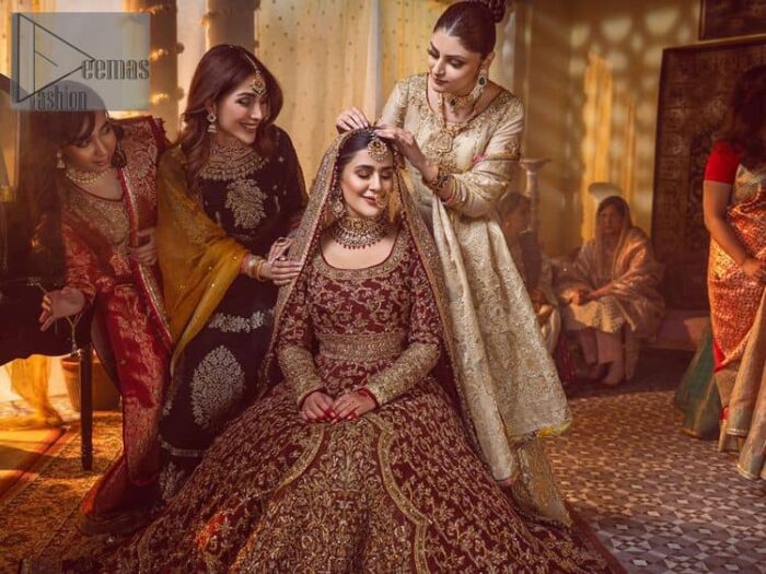 Take me to your heart, for it's there that I belong. A pure outfit base in maroon as a canvas to meticulously designed golden bloomings all over to show the real-time magic of tilla, kora, dabka and zardozi. The round neckline of the traditional pishwas highlighted the incrusted beauty of the outfit. Further, the full sleeve of the following pishwas is wearable art on your big day. It is systemized with a heavy lehenga to give you a more traditional look. Complete this maroon outfit with a dupatta in the same hue having four-sided embellished borders and sequins sprayed all over to show the colour of love.