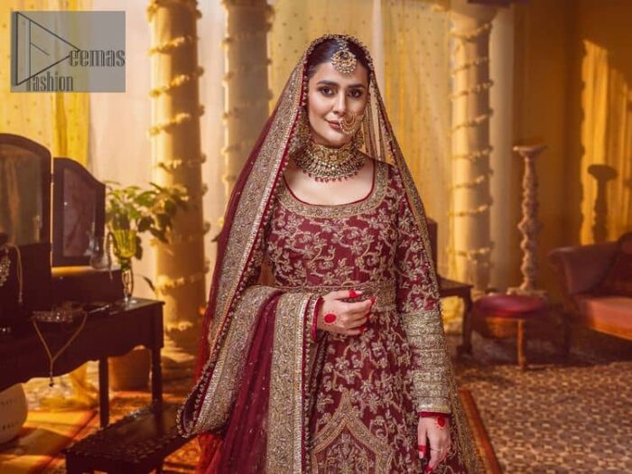 Take me to your heart, for it's there that I belong. A pure outfit base in maroon as a canvas to meticulously designed golden bloomings all over to show the real-time magic of tilla, kora, dabka and zardozi. The round neckline of the traditional pishwas highlighted the incrusted beauty of the outfit. Further, the full sleeve of the following pishwas is wearable art on your big day. It is systemized with a heavy lehenga to give you a more traditional look. Complete this maroon outfit with a dupatta in the same hue having four-sided embellished borders and sequins sprayed all over to show the colour of love.