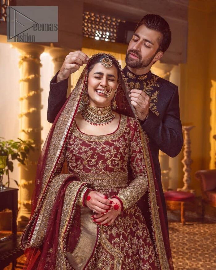Take me to your heart, for it's there that I belong. A pure outfit base in maroon as a canvas to meticulously designed golden bloomings all over to show the real-time magic of tilla, kora, dabka and zardozi. The round neckline of the traditional pishwas highlighted the incrusted beauty of the outfit. Further, the full sleeve of the following pishwas is wearable art on your big day. It is systemized with a heavy lehenga to give you a more traditional look. Complete this maroon outfit with a dupatta in the same hue having four-sided embellished borders and sequins sprayed all over to show the colour of love.