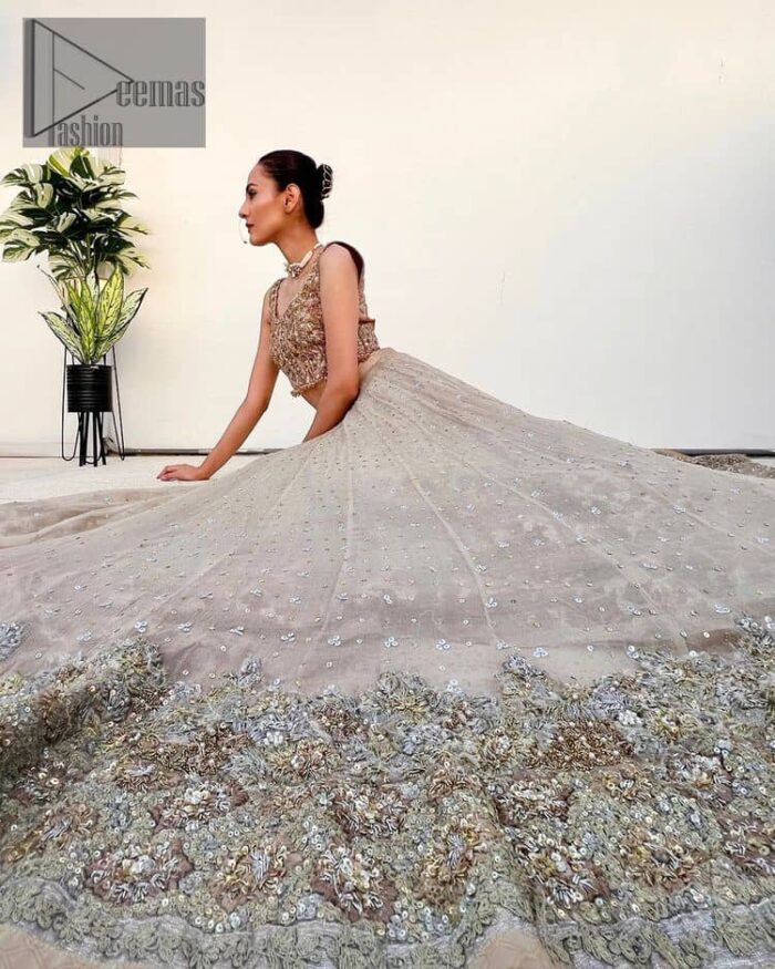 The perfect outfit for walima to enhance your glow. Starting this article with a dream rust blouse having a strap neckline and prominent sleeveless style to embrace the romantic culture. The following blouse is fully embellished with golden embroidery that is prominent with tilla, dabka, kora, pearls and sequins spray to fulfil your dreamy look. It is coordinated with an ivory can-can lehenga whose border is again rendered with golden embroidery and sequins sprayed all over to continue the look. Complete this outfit with a rust dupatta which is embellished with four-sided borders and sequins sprayed all over to enhance the glow of the bride.