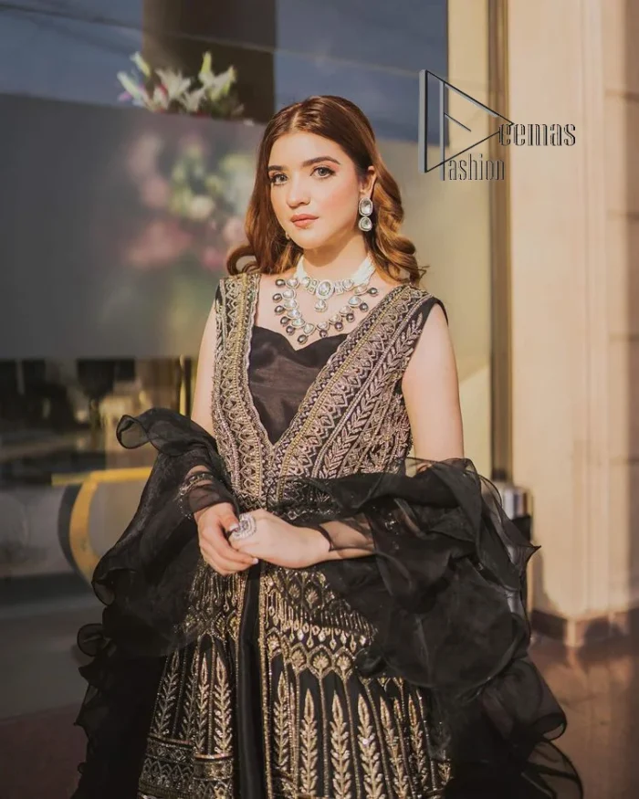 Wear black in-depth to lead colourful lives. DeemasFashion presents black party wear which includes a front open maxi having light golden embroidery which is beautifully decorated with tilla, dabka, kora and Kundan. Further, it is prominent with sleeveless style and sweetheart neckline to make you a memorable girl of the event. The part wear is organized with a frilled lehenga which is a unique core piece. Complete this party wear with a dupatta in the same colour to boost your day with black.