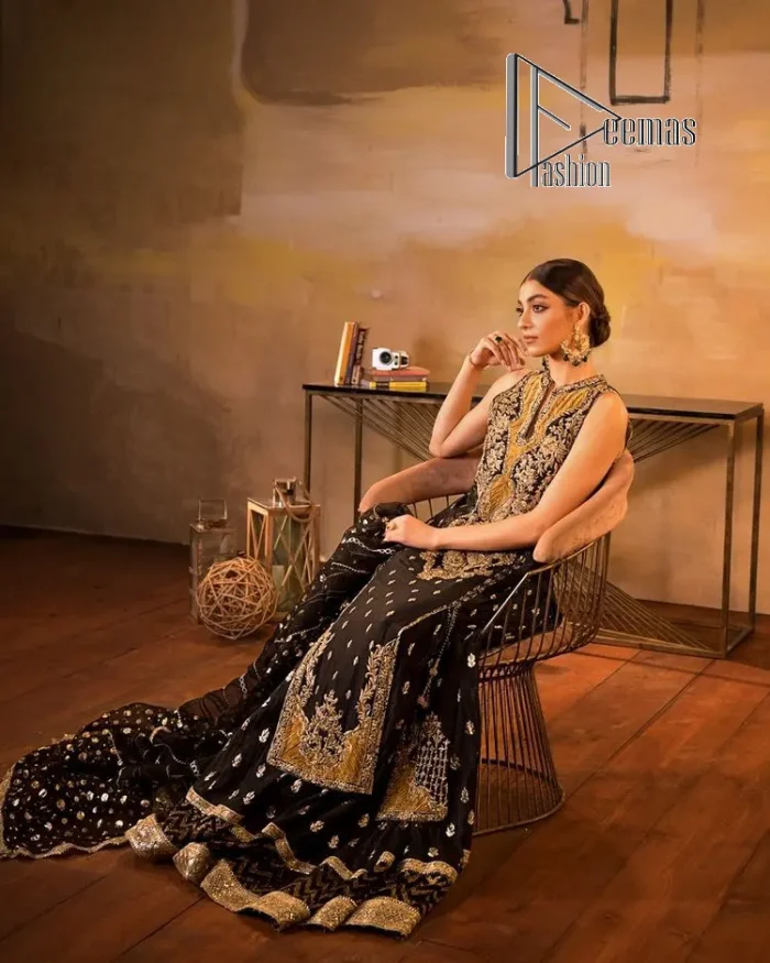 Black is just a vibe in any kind of party. DeemasFashion presents a luscious black base that serves as a canvas for a gorgeous long shirt which is beautifully decorated with light golden embroidery. The fascinating embroidery vague the terms tilla, kora, dabka and zardozi to make your party a shining one. Further, the sleeveless style of the long shirt gives a romantic look to the party wear. It is coordinated with black sharara which is again ornamented with light golden embroidery . In parallel to the shirt and sharara, the dupatta in the same colour is also embellished with four-sided borders as well. 