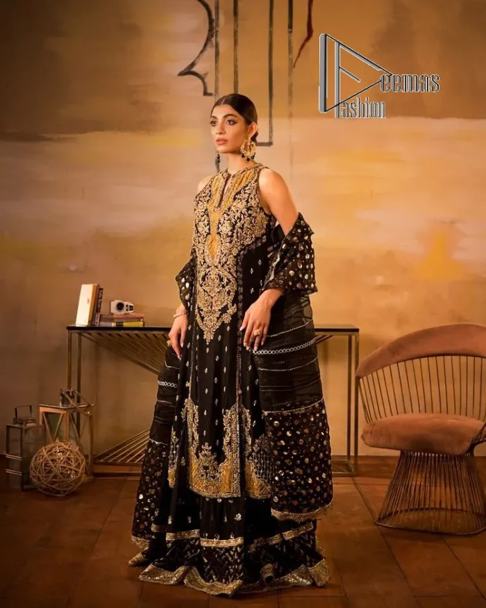 Black is just a vibe in any kind of party. DeemasFashion presents a luscious black base that serves as a canvas for a gorgeous long shirt which is beautifully decorated with light golden embroidery. The fascinating embroidery vague the terms tilla, kora, dabka and zardozi to make your party a shining one. Further, the sleeveless style of the long shirt gives a romantic look to the party wear. It is coordinated with black sharara which is again ornamented with light golden embroidery . In parallel to the shirt and sharara, the dupatta in the same colour is also embellished with four-sided borders as well. 