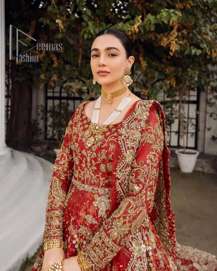 Feels just redish on your Big day to make your day lovely and romantic. DeemasFashion presents this Pakistani reception wear for you in bright red colour which begins with a flared back train maxi. The maxi is attractively and laboriously adorned with golden embroidery that enhances tilla,dabka, kora and Kundan. In addition to this, the boat shape neckline intensifies the beauty of this Pakistani reception wear when comes with full sleeves. The flared back train of the maxi is also heavily embellished. Complete this article with a dupatta in the same colour which is adorned with four-sided borders and tiny floral motifs, sequins spray all over to make you fresh on your Big day.