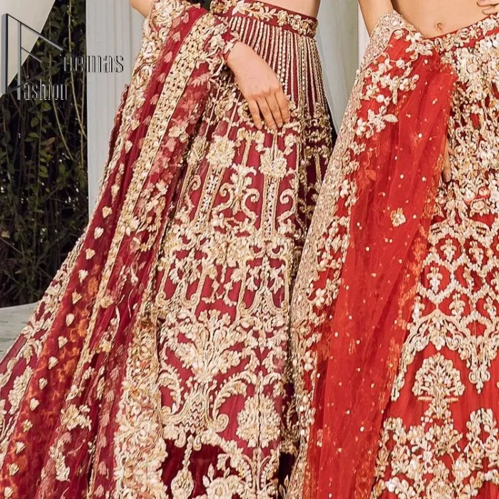 Feels just redish on your Big day to make your day lovely and romantic. DeemasFashion presents this Pakistani reception wear for you in bright red colour which begins with a flared back train maxi. The maxi is attractively and laboriously adorned with golden embroidery that enhances tilla,dabka, kora and Kundan. In addition to this, the boat shape neckline intensifies the beauty of this Pakistani reception wear when comes with full sleeves. The flared back train of the maxi is also heavily embellished. Complete this article with a dupatta in the same colour which is adorned with four-sided borders and tiny floral motifs, sequins spray all over to make you fresh on your Big day.