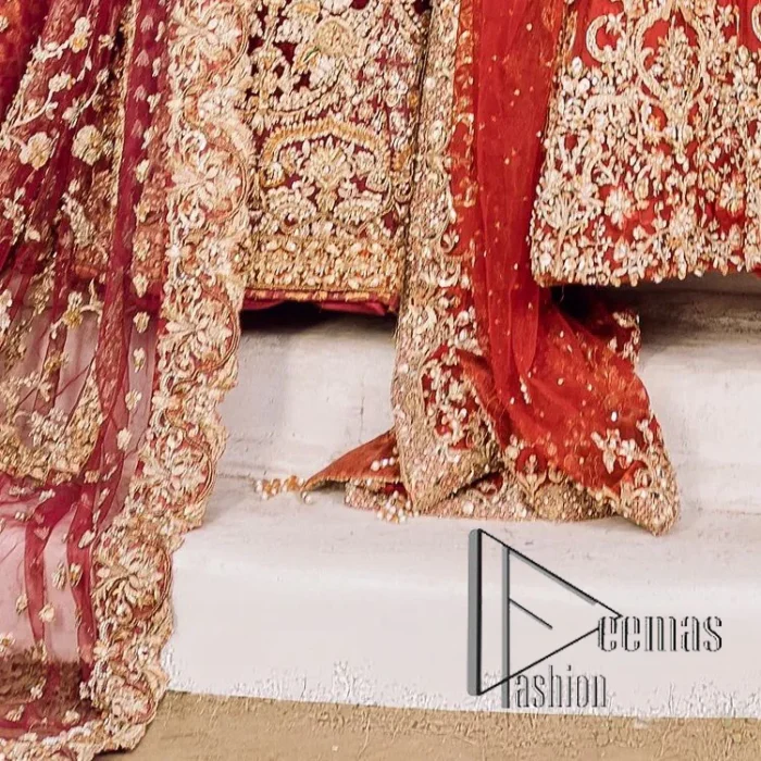 Feels just redish on your Big day to make your day lovely and romantic. DeemasFashion presents this Pakistani reception wear for you in bright red colour which begins with a flared back train maxi. The maxi is attractively and laboriously adorned with golden embroidery that enhances tilla,dabka, kora and Kundan. In addition to this, the boat shape neckline intensifies the beauty of this Pakistani reception wear when comes with full sleeves. The flared back train of the maxi is also heavily embellished. Complete this article with a dupatta in the same colour which is adorned with four-sided borders and tiny floral motifs, sequins spray all over to make you fresh on your Big day.