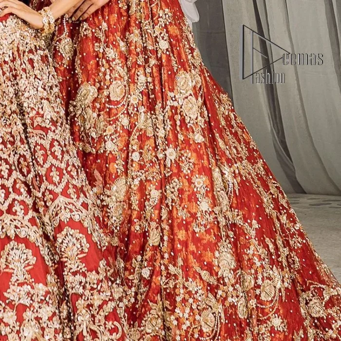 Feels just redish on your Big day to make your day lovely and romantic. DeemasFashion presents this Pakistani reception wear for you in bright red colour which begins with a flared back train maxi. The maxi is attractively and laboriously adorned with golden embroidery that enhances tilla,dabka, kora and Kundan. In addition to this, the boat shape neckline intensifies the beauty of this Pakistani reception wear when comes with full sleeves. The flared back train of the maxi is also heavily embellished. Complete this article with a dupatta in the same colour which is adorned with four-sided borders and tiny floral motifs, sequins spray all over to make you fresh on your Big day.