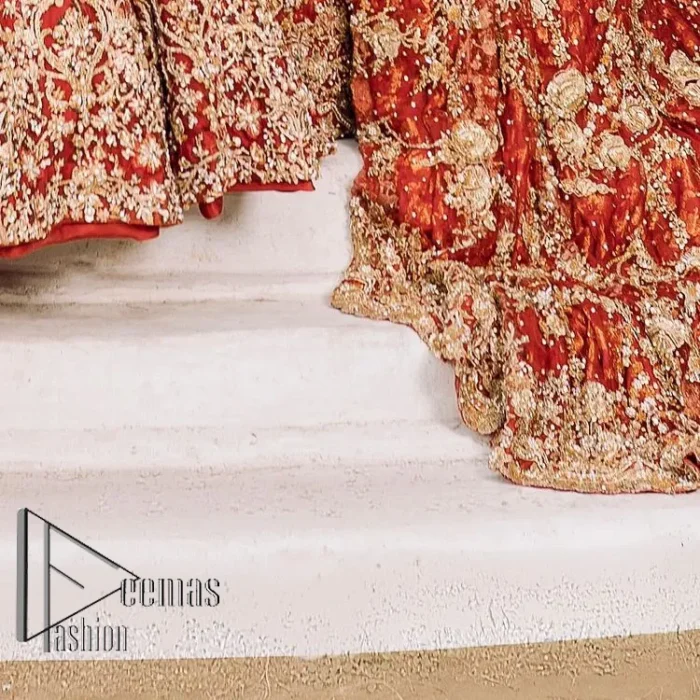 Feels just redish on your Big day to make your day lovely and romantic. DeemasFashion presents this Pakistani reception wear for you in bright red colour which begins with a flared back train maxi. The maxi is attractively and laboriously adorned with golden embroidery that enhances tilla,dabka, kora and Kundan. In addition to this, the boat shape neckline intensifies the beauty of this Pakistani reception wear when comes with full sleeves. The flared back train of the maxi is also heavily embellished. Complete this article with a dupatta in the same colour which is adorned with four-sided borders and tiny floral motifs, sequins spray all over to make you fresh on your Big day.