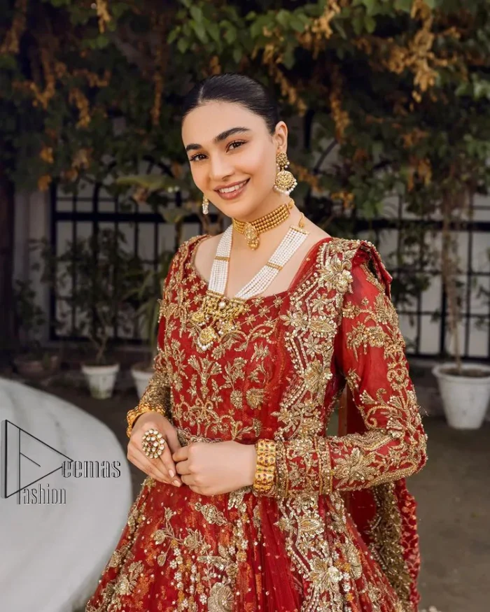 Feels just redish on your Big day to make your day lovely and romantic. DeemasFashion presents this Pakistani reception wear for you in bright red colour which begins with a flared back train maxi. The maxi is attractively and laboriously adorned with golden embroidery that enhances tilla,dabka, kora and Kundan. In addition to this, the boat shape neckline intensifies the beauty of this Pakistani reception wear when comes with full sleeves. The flared back train of the maxi is also heavily embellished. Complete this article with a dupatta in the same colour which is adorned with four-sided borders and tiny floral motifs, sequins spray all over to make you fresh on your Big day.