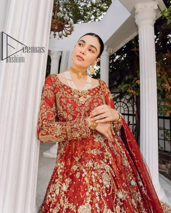 Feels just redish on your Big day to make your day lovely and romantic. DeemasFashion presents this Pakistani reception wear for you in bright red colour which begins with a flared back train maxi. The maxi is attractively and laboriously adorned with golden embroidery that enhances tilla,dabka, kora and Kundan. In addition to this, the boat shape neckline intensifies the beauty of this Pakistani reception wear when comes with full sleeves. The flared back train of the maxi is also heavily embellished. Complete this article with a dupatta in the same colour which is adorned with four-sided borders and tiny floral motifs, sequins spray all over to make you fresh on your Big day.